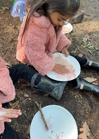 Child painting outdoors.