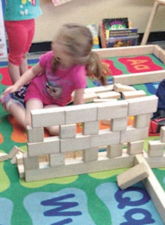 Girl who made a block wall.