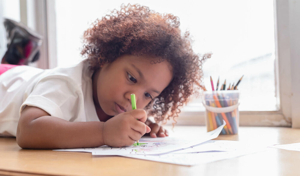 child concentrating on drawing