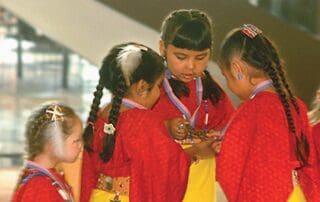 Comanche children looking at their awards for language.