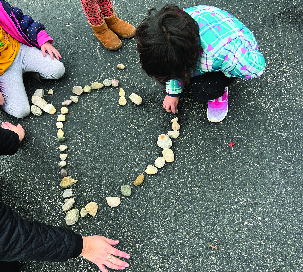 Children arranging natural loose parts.