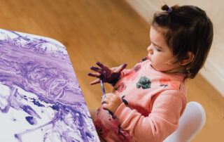 Child painting hand