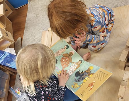 Children looking at a book.