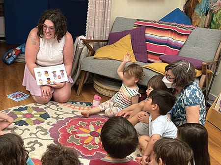 Teacher reading to circle of children.