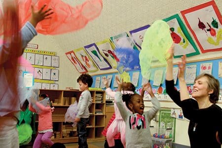 Children and teacher enjoying music