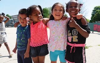 Group of young children embracing