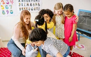 Group of children smiling with teachers