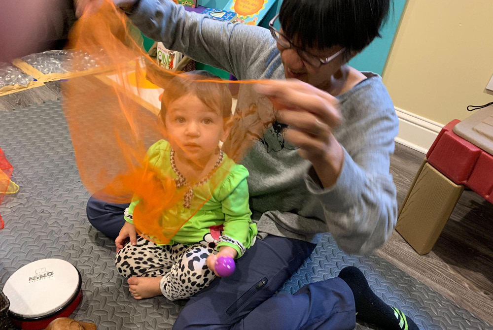 Woman and child play with see-through scarf