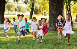 Group of happy children running outside