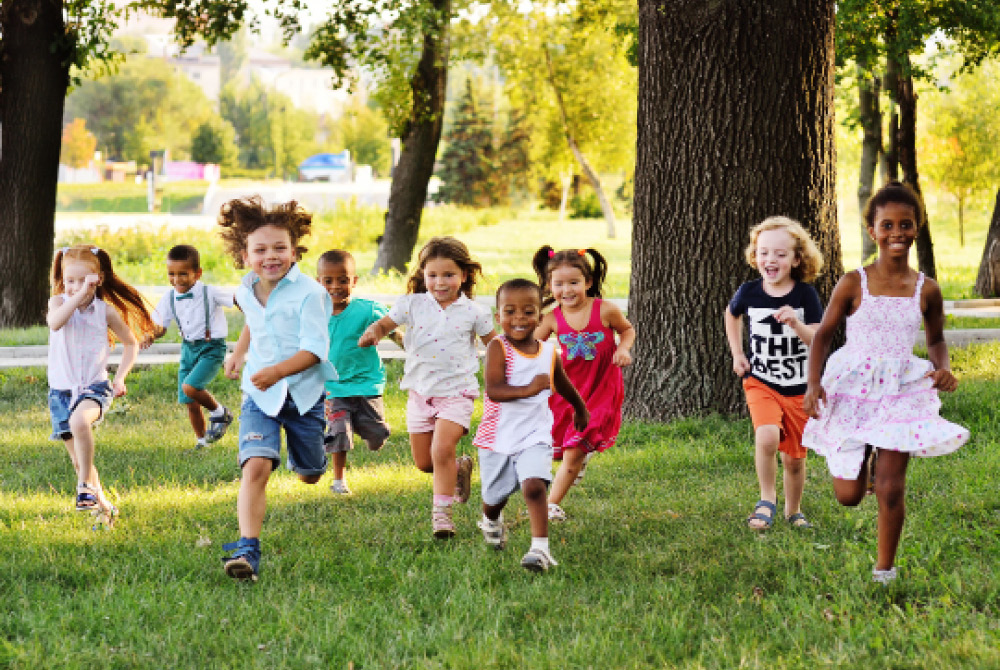 Group of happy children running outside
