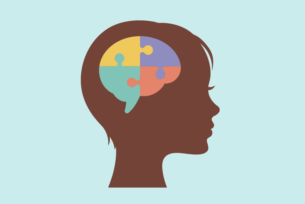 silhouette of child's head with connecting puzzle pieces that form a brain