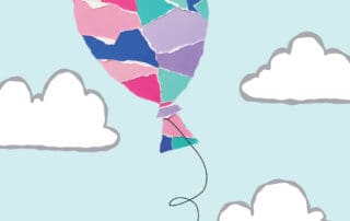 balloon of torn paper floating up above clouds