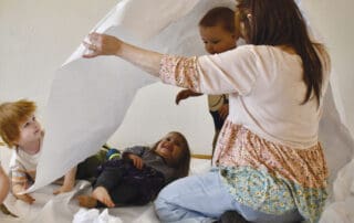 Educator and children playing together