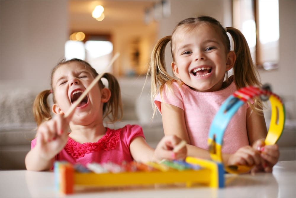 Two children playing music together