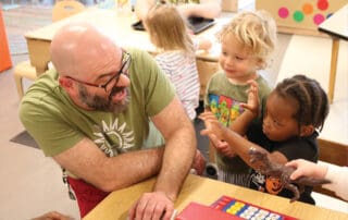Mike Huber engaging in pretend play with children
