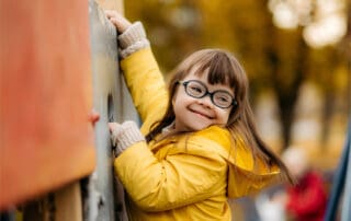 Young girl playing on a climbing structure