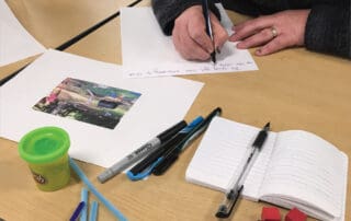 Educator writing documentation of children's learning
