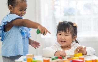 Two children playing with blocks together