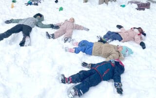 children making snow angels