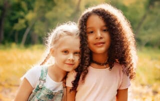 Two young girls hugging