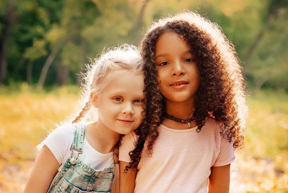 Two young girls hugging