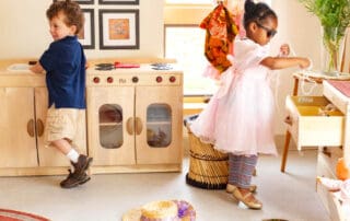 Children exploring a play kitchen