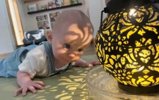 Infant looking at a glowing lantern