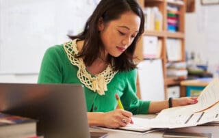 An educator writing