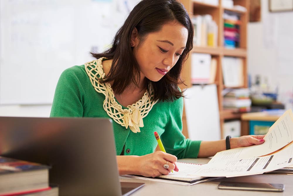 An educator writing