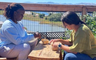 Two educators working with natural materials outdoors