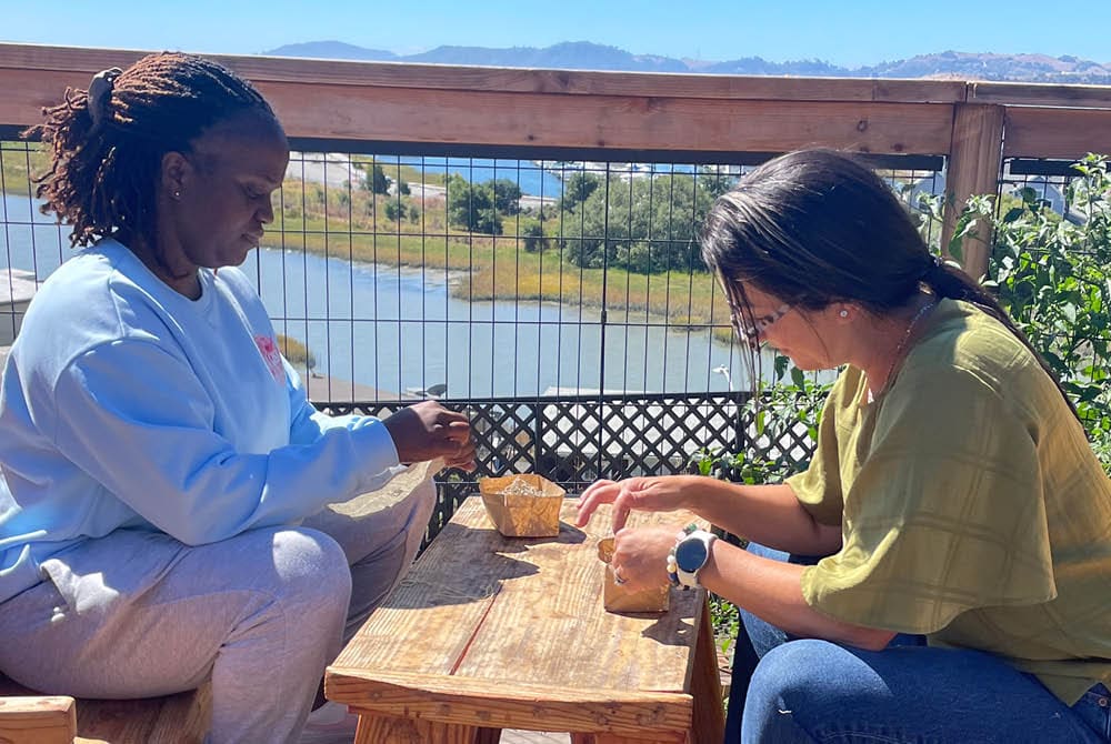 Two educators working with natural materials outdoors
