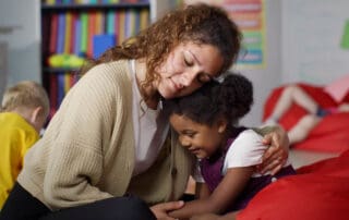 Educator comforts a child