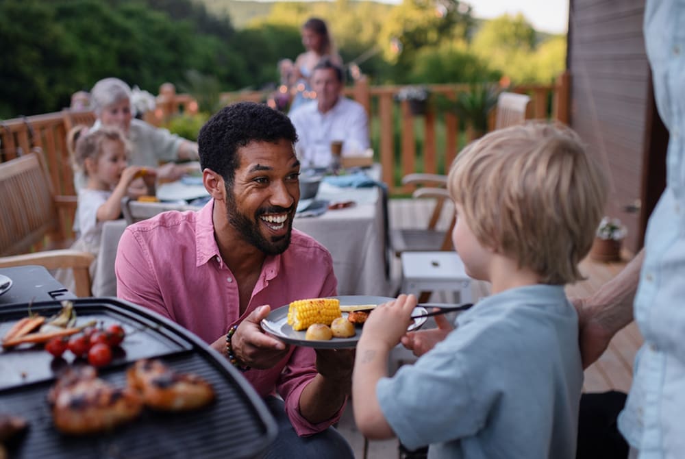 Adult and child at a school cookout